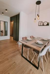 a dining room with a wooden table and chairs at Apartment Rea in Čapljina +4 photos