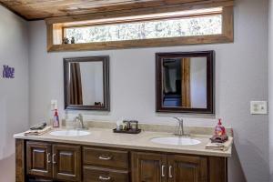 a bathroom with two sinks and a window at Midway Meadows - very Private! in Lead +27 photos