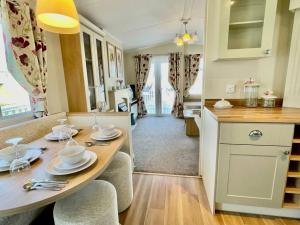 a kitchen with a table and chairs in a room at Idyllic mobile home in beautiful surroundings in Porchfield