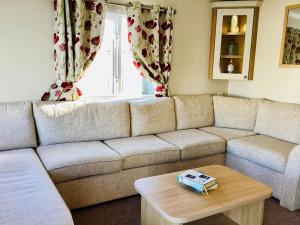 a living room with a couch and a coffee table at Idyllic mobile home in beautiful surroundings in Porchfield