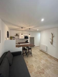 a living room with a couch and a table in it at Logement T2 au coeur du village in Gruissan