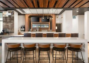 a kitchen with a large white island with bar stools at Courtyard by Marriott Seattle SeaTac Airport in Seattle