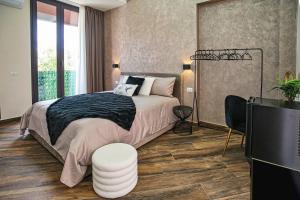 a bedroom with a large bed and a television at Lustru Apartment in Catania