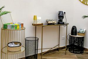 a room with a table with a coffee maker on it at Lustru Apartment in Catania