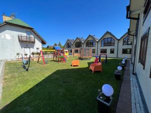 a yard with a playground in a building at Domki letniskowe Gala in Grzybowo