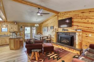 a living room with a fireplace and a tv at Pineview Cabin - Hot Tub in Lead