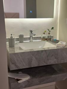 a bathroom counter with a sink and a mirror at غرفة نوم للاسترخاء والراحة in Al Madinah