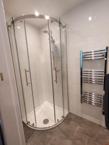 a shower with a glass door in a bathroom at The Beach House in Valley