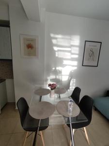 a living room with two tables and two chairs at MontNoir Appartement in Mavrovouni +3 photos
