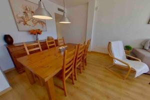 a dining room with a wooden table and chairs at Casa Del Mar in Águilas
