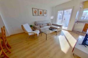 a living room with a couch and a table at Casa Del Mar in Águilas