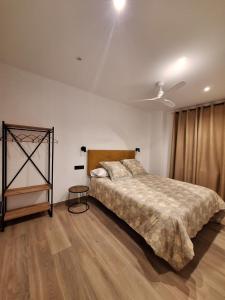 a bedroom with a large bed and a wooden floor at Aromas del Jiloca, Tierra de Trufas in Calamocha