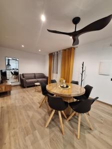 a living room with a table and a ceiling fan at Aromas del Jiloca, Tierra de Trufas in Calamocha