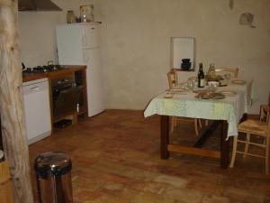 a kitchen with a table with a table cloth on it at Mazaruelle in Calvisson