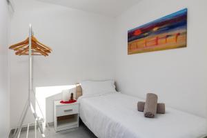 a bedroom with a bed and a painting on the wall at Dubrovnik Domus Apartment in Dubrovnik