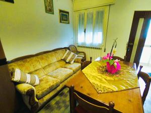 a living room with a couch and a table at Casa vacanze la Bassa in Porto Viro