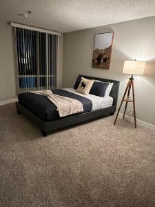 a bedroom with a bed and a lamp and a window at Hollywood two bedroom apartments close to Studios Universal in Los Angeles
