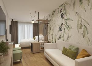 a living room with a couch and a bedroom at Hotel Europa in Sirmione