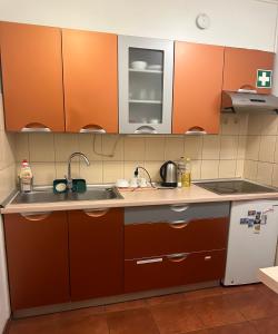 a kitchen with orange cabinets and a sink at Travel House Wroclaw in Wrocław