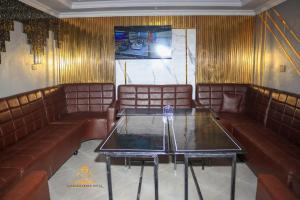 a restaurant with leather couches and a table at TAWALA GARDEN HOTEL in Nairobi