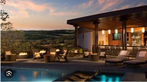 a patio with a pool and chairs and a house at Villas at La Cantera Resort & Spa in San Antonio