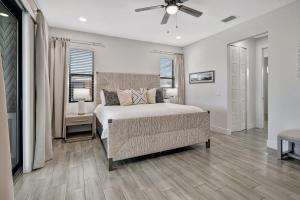 a bedroom with a bed and a ceiling fan at Luxury Retreat in Secret Paradise in Bonita Springs
