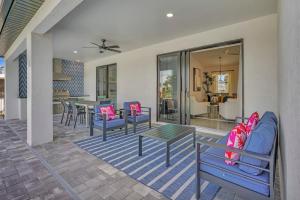 a patio with chairs and a table and a dining room at Luxury Retreat in Secret Paradise in Bonita Springs