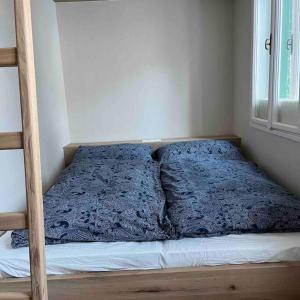 a bed with a blue comforter in a bedroom at Jugendstiljuwel in Bad Gastein in Bad Gastein