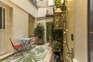 Un balcón con mesa y sillas y plantas. en Young and Happy Latin Quarter by Hiphophostels, en París