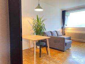- un salon avec une table et un canapé dans l'établissement Bright Studio with View, à Innsbruck