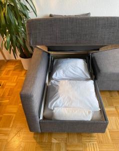 a box with a pillow in it on a floor at Bright Studio with View in Innsbruck