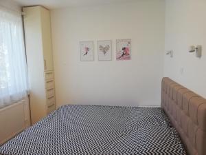 a bedroom with a bed with a black and white bedspread at Villa Hris I WiFi-Netflix in Skopje +17 photos