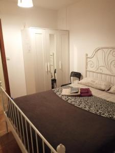 a bedroom with a large bed with a white bed frame at MasRelaxTenerife in La Laguna