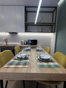 a dining room table with plates and glasses on it at BRAND NEW Luxurious seaside apartment 1 in Durrës