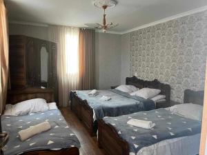 a hotel room with two beds and a mirror at Sunny in Mestia +59 photos