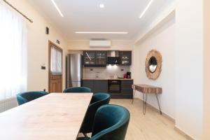 a dining room with a table and chairs at ELEGANCE SUITES in Plataria