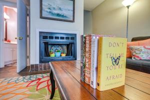 two books sitting on a table in a living room at Bohemian Beach Retreat - 2 Blocks to Ocean! in Myrtle Beach