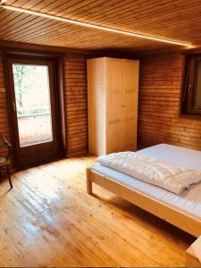 a bedroom with a bed in a room with a window at RIEDER`s Ferienhaus in Ried im Zillertal