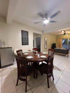 a dining table and chairs in a living room at The Oxford Suite in Bentong