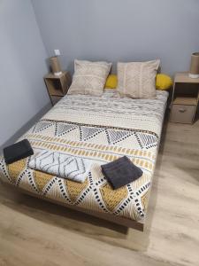 a bed with pillows on it in a room at HOTEL DE LA GARE in Jussey