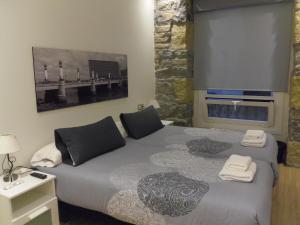 a bedroom with a bed with two towels on it at Talaia HT in San Sebastián