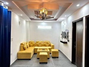 a living room with a couch and a chandelier at Cozy 2bhk near Manipal Hospital Dwarka in New Delhi