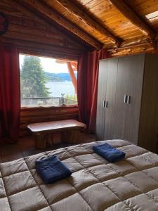 a bedroom with a large bed and a large window at Le Château in San Carlos de Bariloche