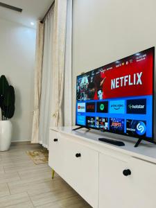 a flat screen tv sitting on top of a white dresser at Entire Furnished Apartment Unit in Kira in Kira