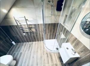 a bathroom with a shower and a sink and a toilet at Charming En-Suite in London in London