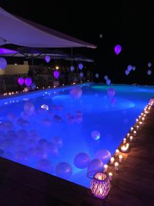 a swimming pool with purple lights and balloons at Roshan Resorts in Bhopal