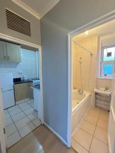 a bathroom with a tub and a sink at 1 bedroom flat in Whitechapel, London in London