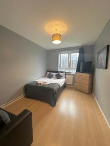1 dormitorio con 1 cama y TV de pantalla plana en 1 bedroom flat in Whitechapel, London en Londres