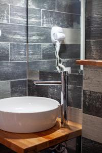 a bathroom with a white sink on a wooden counter at Voskopoje in Korçë