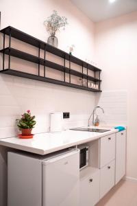 a white kitchen with a sink and a counter at Домик 2 Kok Tobe Village in Almaty +11 photos